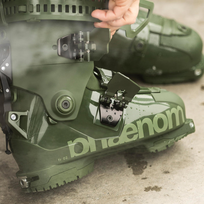 Skier putting on green freeride and touring ski boot phaenom fr 110