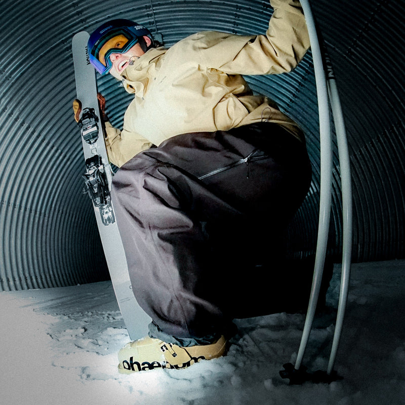 Skier holding Faction skis wearing phaenom fs 02 110 freestyle all mountain ski boots